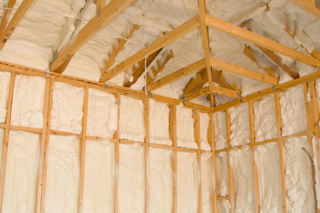 Interior view of a room showing wood framing and insulation, illustrating the building's thermal insulation features.